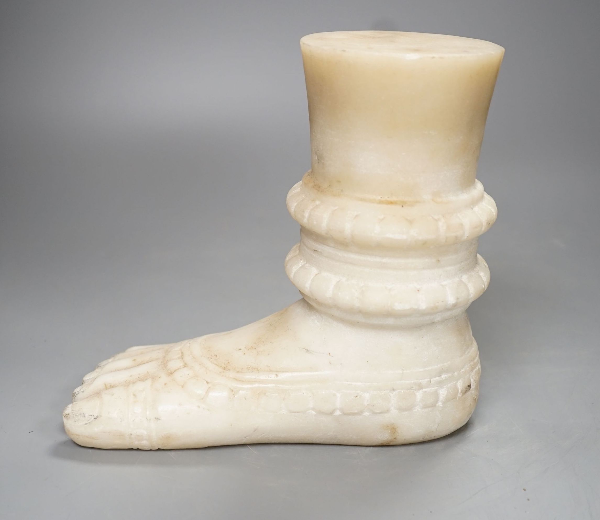 An Indian white marble foot of a deity - 18cm high